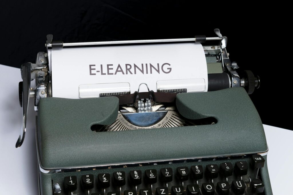 Close-up of a vintage typewriter displaying the concept of e-learning on paper.